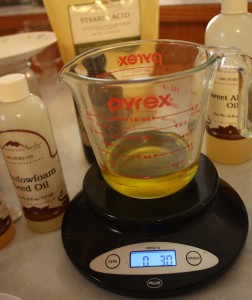 a cup of melted oils on a scale