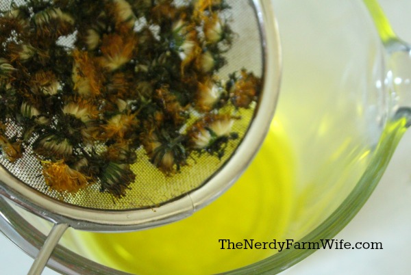 Straining dandelions from coconut oil