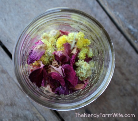 jar with rose petals and helichrysum flowers