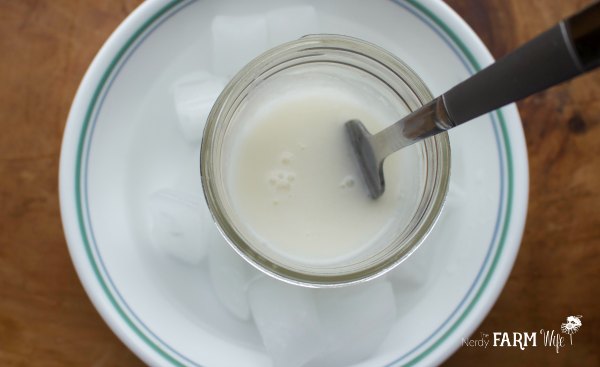 mixing a glass of lotion with a fork