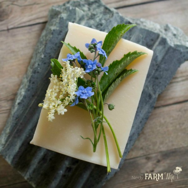 a bar of simple soap decorated with forget me not and elderflowers