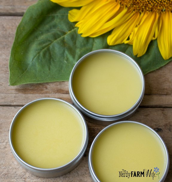 tins of salve on a wooden background