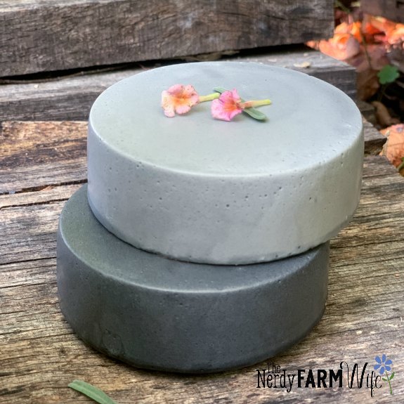 two stacked round soaps made with charcoal