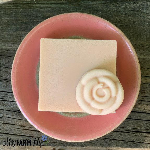 soap made with pink Brazilian clay on wooden background and small pink saucer