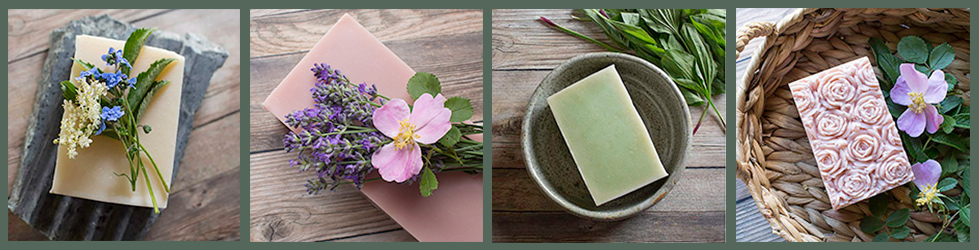 multiple herbal soaps in a row on green background