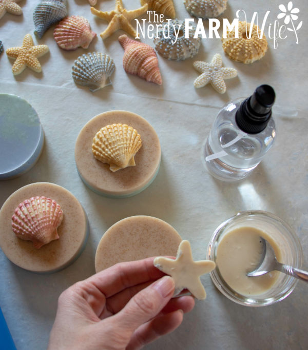 Small shell soaps being attached to beach bar bases with melted soap base