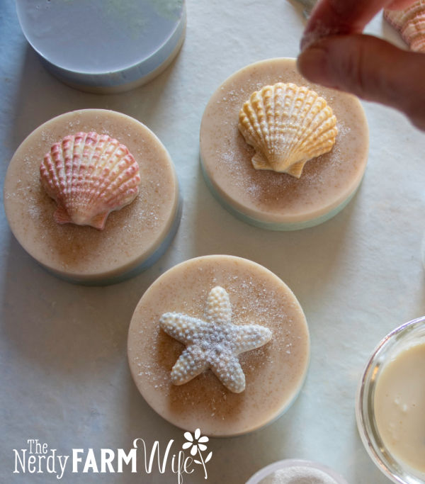 Beach bar soap with attached shells being sprinkled with bio glitter