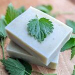 stack of bars of soap with nettle leaves