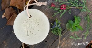 a bar of melt and pour soap on a rope with cedar and a wooden board background